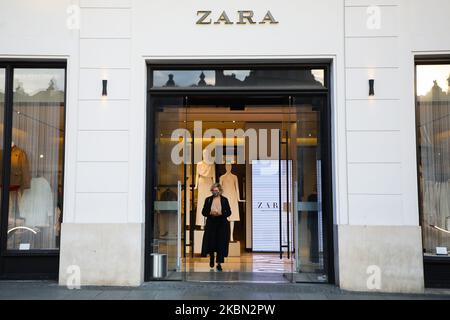 A woman wearing a protective face mask due to the spread of coronavirus is seen walking out Zara shop at the Main Square in Krakow, Poland on April 28, 2020. The rule of covering the nose and mouth in public places with face masks, carves or handkerchiefs came into force from April 16th. The order will not apply to children up to the age of two and people who are unable to cover their mouth or nose due to breathing difficulties. (Photo by Beata Zawrzel/NurPhoto) Stock Photo