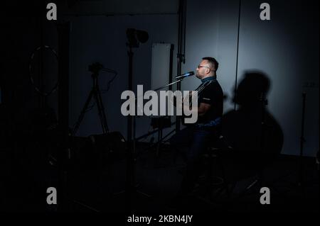 Deyan Stoev rehearses before live streaming. Musicians are organizing secret concerts on balconies in Varna, Bulgaria every Thursday. The musicians self-organized and choose different balconies of apartament buildings around the city to lift the spirits of the neighborhoods during quarantine. They also live stream them on the social medias for the people, Varna, Bulgaria on April 30, 2020 (Photo by Hristo Rusev/NurPhoto) Stock Photo