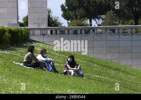 A group of women wearing protective masks rests in the gardens of Eduardo VII Park in Lisbon. 01 May 2020. Portuguese Prime Minister AntÃ³nio Costa announced on Thursday a sector-by-sector plan to gradually lift the blockade measures imposed six weeks ago to combat the COVID-19 outbreak in the country. May 2 will be the last day Portugal is in a state of emergency, the next day it will move to a 'calamity' state, which involves less restrictive measures but will continue with movement controls. (Photo by Jorge Mantilla/NurPhoto) Stock Photo