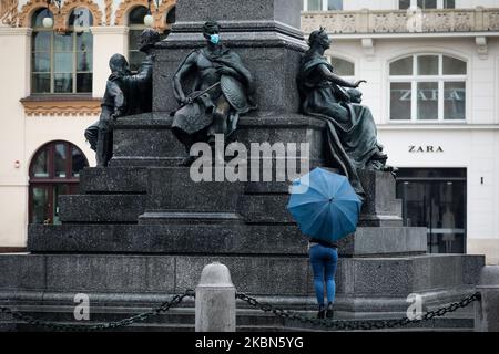 A sculpture being a fragment of Adam Mickiewicz statue is seen wearing a protective face mask during the spread of coronavirus. Krakow, Poland on May 1at, 2020. The rule of covering the nose and mouth in public places with face masks, carves or handkerchiefs came into force from April 16th. The order will not apply to children up to the age of two and people who are unable to cover their mouth or nose due to breathing difficulties. (Photo by Beata Zawrzel/NurPhoto) Stock Photo