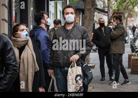 On 22 April, 2020, Turkish shoppers wearing masks stood in line outside a grocery store in the Cihangir neighborhood of Istanbul. Istanbul is the center of the Covid-19 pandemic in Turkey, many residents continued their daily routines despite social distancing guidelines, though some practice self-isolation and wear masks in the streets. (Photo by Diego Cupolo/NurPhoto) Stock Photo