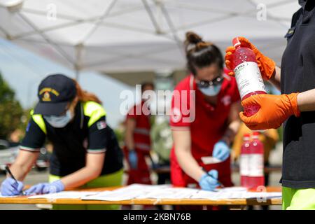 A Factory in Correggio donates alcohol bottles to be distributed by Red Cross and Civil Protection during COVID-19 pandemic in Italy on May 2, 2020 in Correggio, Italy. (Photo by Emmanuele Ciancaglini/NurPhoto) Stock Photo