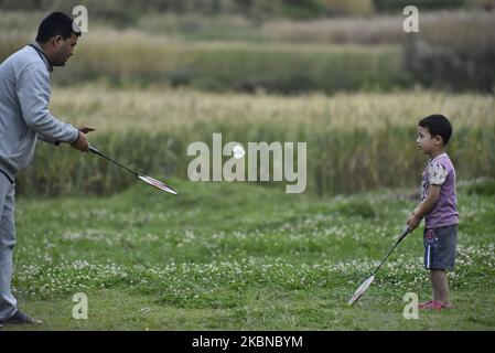 A Father along with his son playing Badminton in the green field during complete nation lockdown as concerns about the spread of Corona Virus (COVID-19) at Bhaktapur, Nepal on Tuesday, May 05, 2020. (Photo by Narayan Maharjan/NurPhoto) Stock Photo