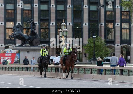 Mounted police officers ride across Westminster Bridge during the weekly 'Clap for our Carers' applause for the NHS and key workers on the front line of the coronavirus (Covid-19) pandemic as the UK's nationwide lockdown continues for the seventh week on 07 May, 2020 in London, England. (Photo by WIktor Szymanowicz/NurPhoto) Stock Photo