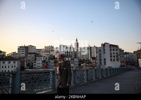 A man walks on deserted Galata Bridge during the curfew in Istanbul, Turkey on May 09, 2020. Turkey has reimposed a 48-hour curfew in 24 provinces beginning at midnight as part of measures to stem the spread of the novel coronavirus, the country’s Interior Ministry announced. (Photo by Cem Tekke?ino?lu/NurPhoto) Stock Photo