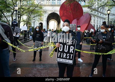 A large group of protesters, bound together with yellow caution tape, marched on New York's Police Headquarters decrying police brutality against African-Americans following the killing of Ahmaud Arbery, 11 May 2020, in New York. (Photo by B.A. Van Sise/NurPhoto) Stock Photo