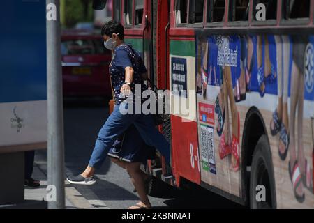 A commuter board a bus wearing a face mask as preventive measure in Bangkok on May 12, 2020 in Bangkok, Thailand. (Photo by Vachira Vachira/NurPhoto) Stock Photo