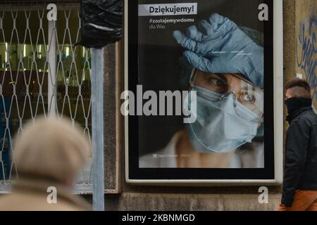 People walk by a Poster 'Thank you To Healthcare Professionals' in Krakow center seen on the on International Nurses Day. On Tuesday, May 12, 2020, in Krakow, Poland. (Photo by Artur Widak/NurPhoto) Stock Photo