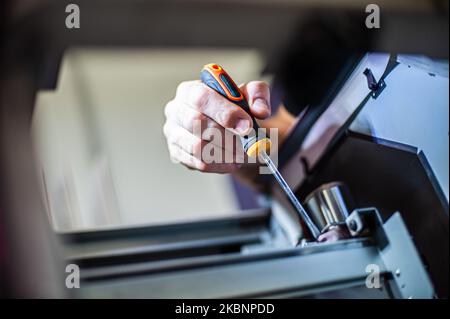 All machines nead maintains. Professional technician troubleshooting and repair the machines in the printing house. Stock Photo