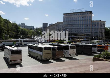 Passengers buses are seen on the Evropeyska Square during a protest demanding to restore domestic and international transportation, in Kyiv, Ukraine, on 13 May, 2020. Bus drivers from all over the country gathered for the protest in the center of the Ukrainian capital. The carriers demand permission from the Cabinet of Ministers for domestic and international transportation, suspended due to the introduction of quarantine due the COVID-19 coronavirus, as local media reported. The placards placed on the buses the inscriptions said 'Restore bus communication!', 'Why does transport work in Europe Stock Photo