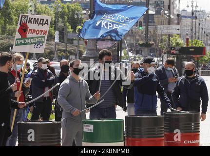 A group of investors of residential complexes wearing protective face masks amid the Covid-19 coronavirus outbreak, take part at a rally with demand the resumption of construction of the complexes, near the city Hall in Kyiv, Ukraine, on 13 May, 2020. Investors of several residential complexes took part in a car rally with demand resumption the residential complexes of construction which has been idle since summer 2019, according to local media. (Photo by STR/NurPhoto) Stock Photo