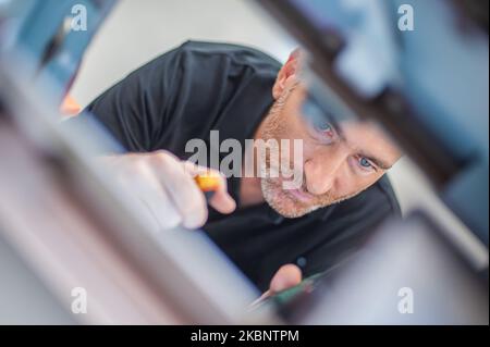 All machines nead maintains. Professional technician troubleshooting and repair the machines in the printing house. Stock Photo