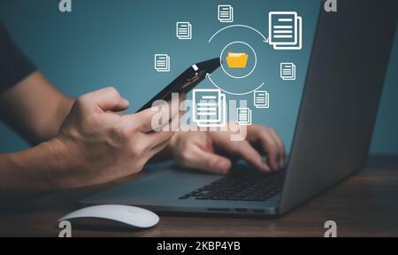 Files Transfer technology. User using Mobile Phone  connection between Smart phone and computer to transfer document and image. Stock Photo