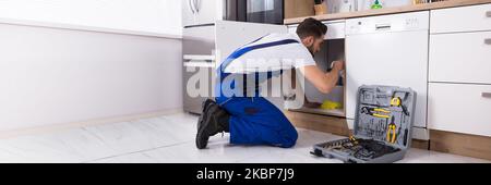 House Sink Plumbing. Plumber Installing Pipe In Kitchen Stock Photo