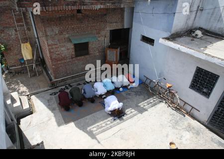 A muslim family offers a special prayer in their home during the Eid-al-Fitr festival, which marks the end of Islamic holy fasting month of Ramadan, in New Delhi on May 25, 2020. - Muslims around the world began marking a sombre Eid al-Fitr, many under coronavirus lockdown, but lax restrictions offered respite to worshippers in some countries despite fears of skyrocketing infections. (Photo by Ritesh Shukla/NurPhoto) Stock Photo