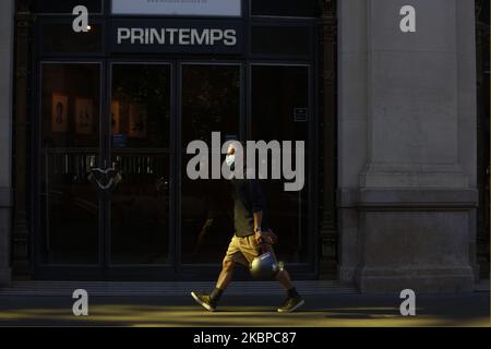 People walk a front the Printemps shop in Paris on May 28 2020