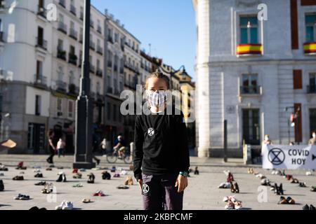 Children participating in the Extinction Rebellion movement, suggesting the XR flags and posters asking governments to act now in the face of the climate crisis in Plaza del Sol, Madrid, on May 29, 2020. (Photo by Jon Imanol Reino/NurPhoto) Stock Photo