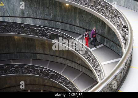 (EDITORIAL NEWS USE ONLY â€“ STRICTLY NO COMMERCIAL OR MERCHANDISING USAGE) People wearing masks to prevent the spread of coronavirus, walk down a staircase designed by Giuseppe Momo in 1932, inspired by the original Bramante staircase designed by Renaissance architect Donato Bramante, as the Vatican Museum reopened, in Rome, Monday, June 1, 2020. The Vatican Museums reopened Monday to visitors after three months of shutdown following COVID-19 containment measures. (Photo by Massimo Valicchia/NurPhoto) Stock Photo