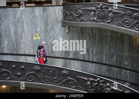 (EDITORIAL NEWS USE ONLY â€“ STRICTLY NO COMMERCIAL OR MERCHANDISING USAGE) People wearing masks to prevent the spread of coronavirus, walk down a staircase designed by Giuseppe Momo in 1932, inspired by the original Bramante staircase designed by Renaissance architect Donato Bramante, as the Vatican Museum reopened, in Rome, Monday, June 1, 2020. The Vatican Museums reopened Monday to visitors after three months of shutdown following COVID-19 containment measures. (Photo by Massimo Valicchia/NurPhoto) Stock Photo