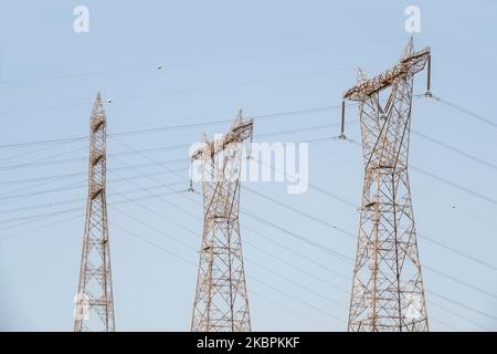 Close up details of sections of a high voltage electricity pylon against a blue sky Stock Photo