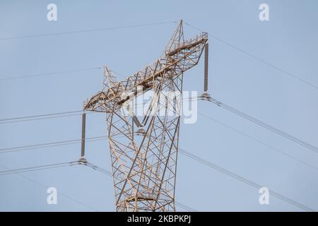 Close up details of sections of a high voltage electricity pylon against a blue sky Stock Photo