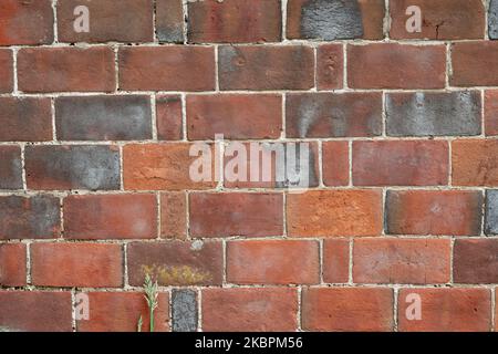 Close up area of antique red brick wall laid in 'Garden Wall Bond' Stock Photo