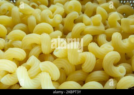 Close up of yellow gimlet pasta, top view Stock Photo