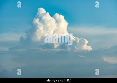 White-gray puff clouds high in the sky, summer view Stock Photo