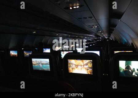 Interior of a cabin in Economy Class of an Airbus A321 NEO during a flight. Flying with Turkish Airlines during the COVID-19 Coronavirus pandemic outbreak era. Fewer passengers are onboard in an almost empty airplane to fly, while passengers cabin crew and flight attendants are wearing protective face masks. The International flight TK 1843 from Istanbul New Airport in Turkey to the capital Athens in Greece is operated by a new modern, sophisticated and advanced aircraft, an Airbus A321neo with registration TC-LSN. (Photo by Nicolas Economou/NurPhoto) Stock Photo
