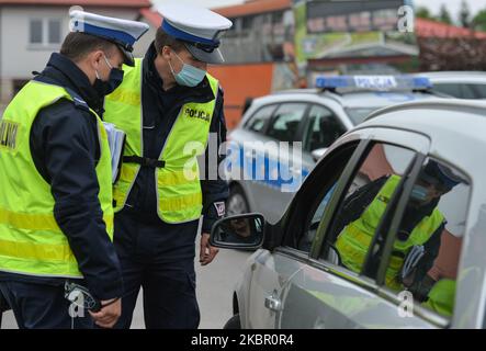 Two police officers seen during a speed check on the national road 94, near the village of Bialy Kosciol. Krakow's Police Road Traffic Department has introduced a new initiative called 'From Katowice to Krakow, is the speed correct'. From June 8th, road patrols of the Lesser Poland and Silesian regions will be focused on improving the safety of road users and eliminating behaviors that have a negative impacts on road safety. On June 8, 2020, in Bialy Kosciol, Krakow County, Poland. (Photo by Artur Widak/NurPhoto) Stock Photo