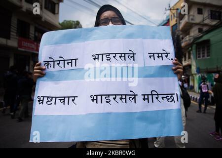 A protestor hold placards during a protest near prime Minister’s residence demanding better testing for coronavirus disease (COVID-19) in Kathmandu, Nepal. 09 June 2020. (Photo by Rojan Shrestha/NurPhoto) Stock Photo