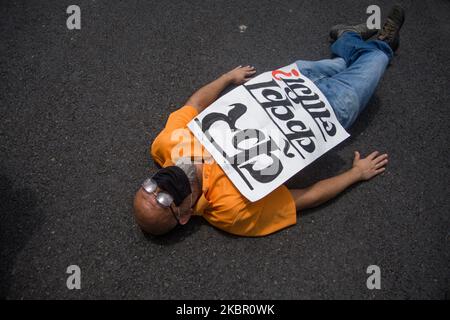 A protestor lies on the road during a protest near prime Minister’s residence demanding better testing for coronavirus disease (COVID-19) in Kathmandu, Nepal. 09 June 2020. (Photo by Rojan Shrestha/NurPhoto) Stock Photo
