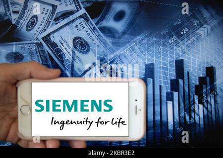 In this illustration is displayed on a smartphone's screen the company logo of Siemen, which specialises in power generation technology, is shown on the screen of a smartphone in front of a blue backdrop of the global stock markets and worldwide indices in Frankfurt, Germany, on 12th June, 2020. It is one of the global companies that provides innovative solutions for hydrogen production in the current alternative energy market. (Photo Illustration by Alexander Pohl/NurPhoto) Stock Photo