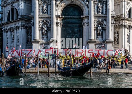 At least 1500 people have been demonstrating in Venice, Italy, on June 13, 2020 asking a regulation against mass tourism in Venice. After the coronavirus emergency the tourism industry in Venice collapsed, but many locals are asking new rules for the future. At the demonstration took part also people against big ships coming into Venice. (Photo by Giacomo Cosua/NurPhoto) Stock Photo