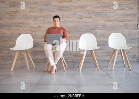 Interview, laptop and woman waiting for a recruitment meeting alone in the modern office. Hiring, technology and professional lady from Canada doing Stock Photo
