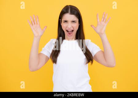 Screaming hate rage woman face. Emotional angry woman screaming on studio isolated background. Human emotions, expressive facial expressions. Panic Stock Photo