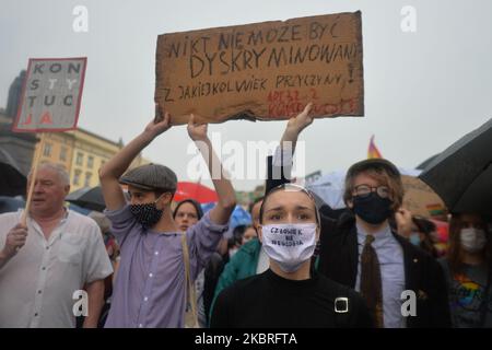 Members of the LGBT community during a protest against discrimination in Krakow's Main Square next to the place where the Polish President Andrzej Duda holds a campaign rally at the same time. On Sunday, June 21, 2020, in Krakow, Poland. (Photo by Artur Widak/NurPhoto) Stock Photo