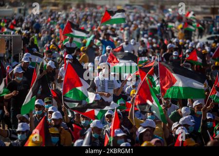 Demonstrators take part in a rally, organised by the Palestinian Liberation Organization (PLO), to protest against Israel's plan to annex parts of the West Bank, in Jericho June 22, 2020. The Israeli government is reportedly preparing to annex parts of the West Bank that were first occupied by the IDF in the 1967 Six-Day War. The annexation of up to 30 percent of the occupied Palestinian territory, deemed illegal under extant international law, would fulfill a campaign promise pledged by Israeli Prime Minister Benjamin Netanyahu during the recent general elections. The move has the full backin Stock Photo