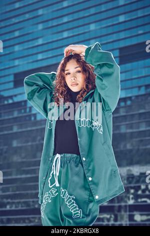 Portrait, fashion and city with a black woman model outdoor posing in contemporary clothing style. Building, street and clothes with a young, trendy Stock Photo