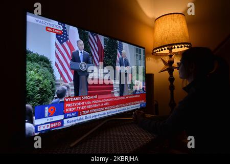 A lady watches a televised press conference from the White House with Polish President Andrzej Duda and US President Donald Trump, on TVP Info. On June 24, 2020, in Krakow, Lesser Poland Voivodeship, Poland. (Photo by Artur Widak/NurPhoto) Stock Photo