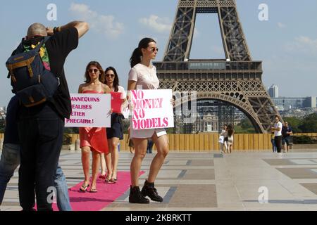 People who work in fashion parade with signs denouncing precariousness during covid19 on the trocadero square in front of the eiffel tower in Paris on June 25, 2020. (Photo by Mehdi Taamallah/NurPhoto) Stock Photo
