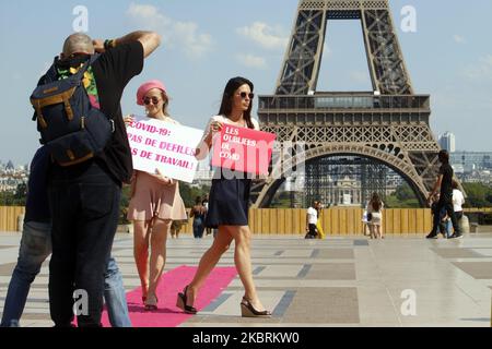People who work in fashion parade with signs denouncing precariousness during covid19 on the trocadero square in front of the eiffel tower in Paris on June 25, 2020. (Photo by Mehdi Taamallah/NurPhoto) Stock Photo