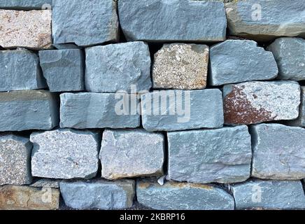 Stone wall from rough stones. background Stock Photo