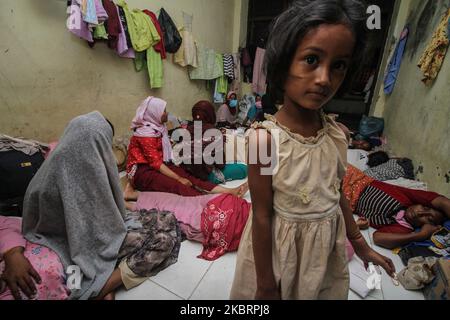 Rohingya ethnic people were seen resting at an immigration shelter in Lhokseumawe, on June 27, 2020, in Aceh Province, Indonesia. According to reports, around 100 Rohingya who was stranded off the coast of Aceh were pulled to the shore of Lancok Village on June 25 by local residents after a refusal from the authorities to give them protection. (Photo by Fachrul Reza/NurPhoto) Stock Photo