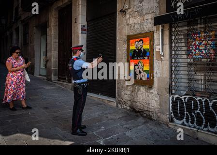 A man takes a photo to a graffiti by street artist TVBoy painted a graffiti with far right politicians on top of a gay pride flag in Barcelona, Spain, on June 27, 2020. (Photo by Adria Salido Zarco/NurPhoto) Stock Photo