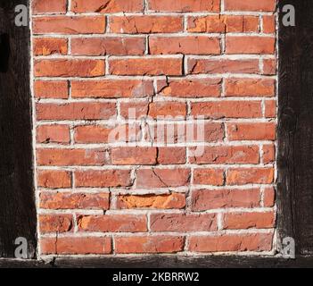 Crack in an old barn wall, red clinker brick Stock Photo