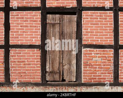 Old door in rustic brick wall Stock Photo