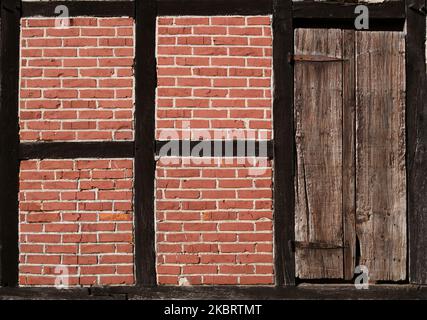 Old door in rustic brick wall Stock Photo