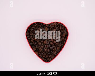 Coffee beans in the shape of a heart against a white background. copy space Stock Photo