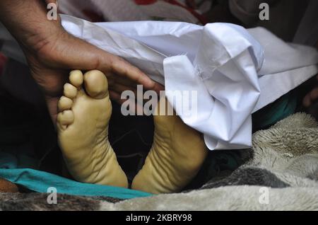 (EDITORS NOTE: Image depicts death.) A relatives touching the feet of a civilian Bashir Ahmad during his last rites in HMT Srinagar, Kashmir on July 01, 2020.One Indian soldier and a civilian (grandfather) of a three-year old baby were killed after militants attacked patrolling party of Indian soldiers in Sopore area of north Kashmir. A police official told local news agency that the civilian Bashir Ahmad of Srinagar who was carrying a three-year old baby in his lap also died after receiving bullets. (Photo by Faisal Khan/NurPhoto) Stock Photo